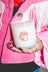 White coconut soy candle with saddle leather scent and red assless chaps cowboy hat design on the side