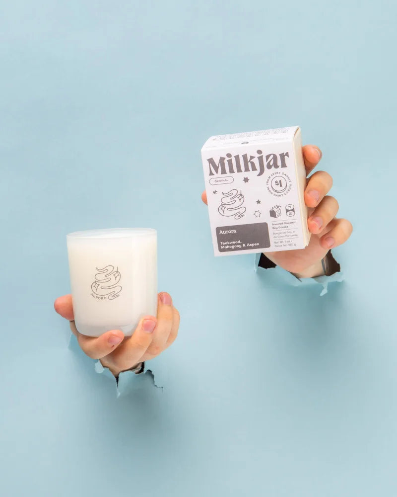 White milkjar aurore mahogany teakwood aspen coconut soy wax candle in frosted glass with minimalist logo design