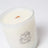 A white glass aurora candle with orange wooden wick and black logo made from coconut soy wax in mahogany teakwood scent