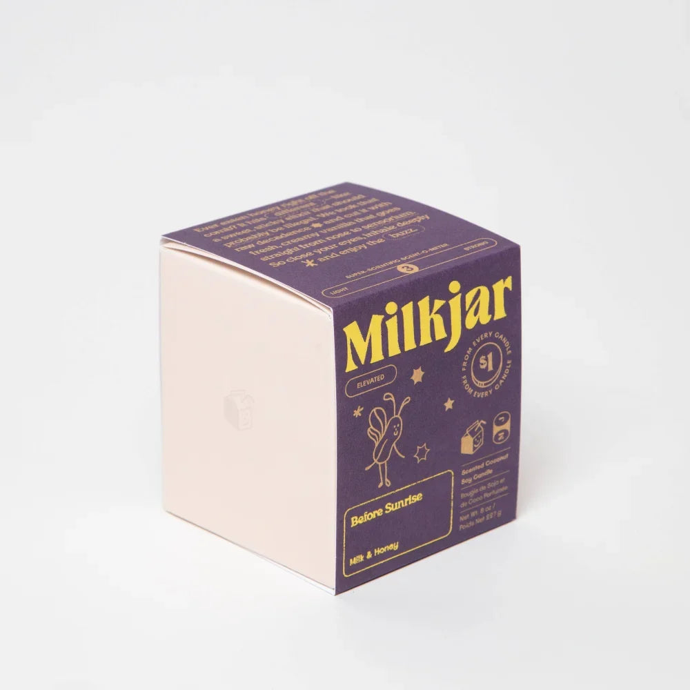 Purple and cream coconut soy candle box for milkjars before sunrise scent with gold foil lettering and illustrations
