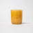 A translucent amber glass coconut soy candle jar from milkjar branded before sunrise milk and honey scent