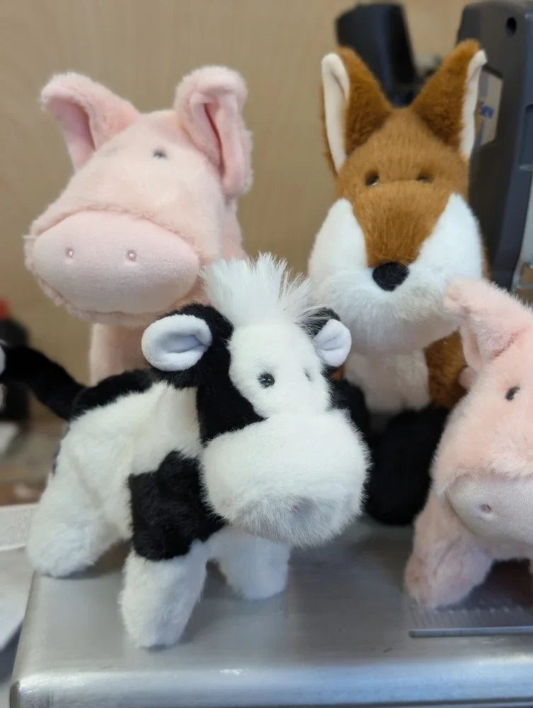 Soft plush black and white cow toy with a fluffy texture perfect for cuddling and playtime fun