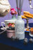 A frosted glass blueberry tea reed diffuser bottle with white etched teacup design and gray reed sticks by angus oliver