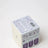 White box with purple text labeled safety time blueberry tea coconut soy wax candle hand poured in sunny calgary 2016