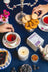 A white milkjar tea box with a purple label showing teapots and soy wax blueberry tea coconut soy candle
