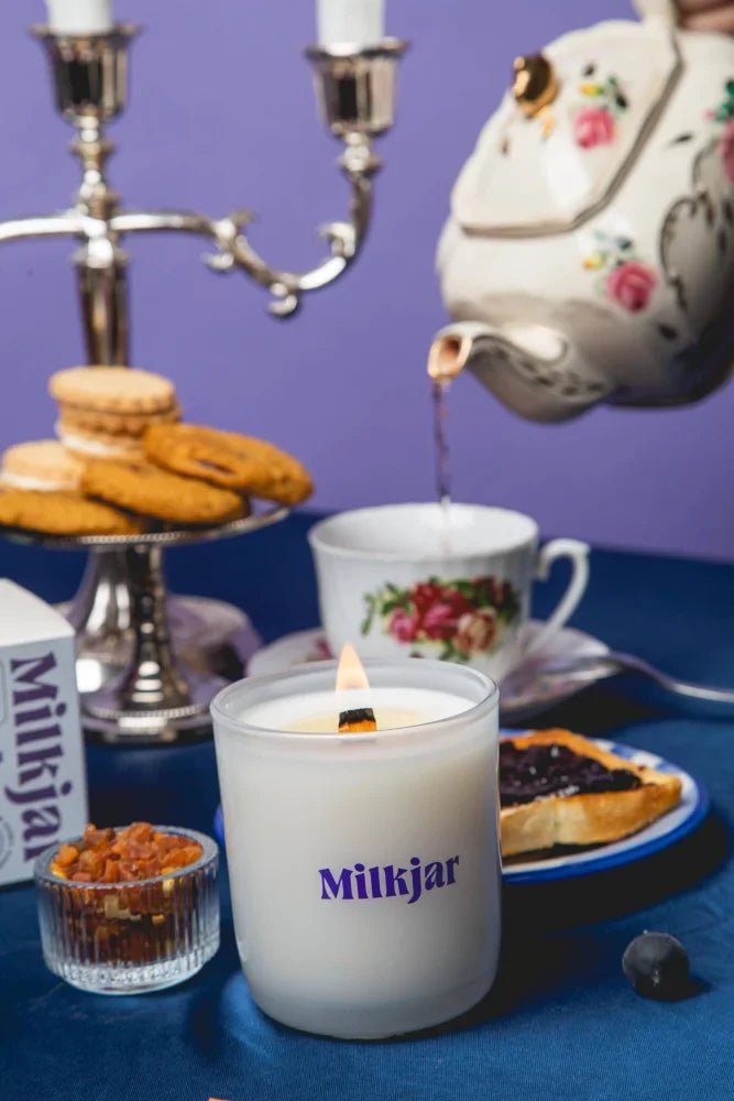 White milkjar blueberry tea candle in frosted glass with purple branding made from coconut soy wax