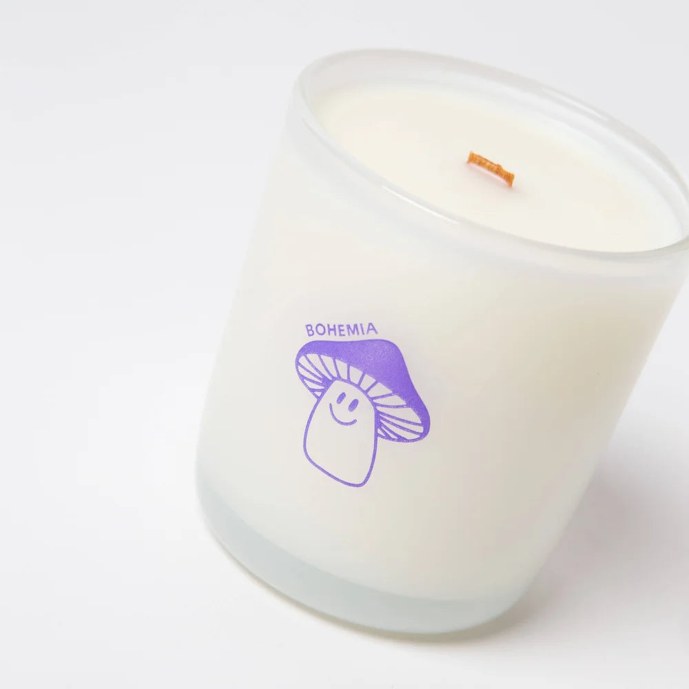 White glass candle jar with purple smiling mushroom design and bohémia text made with coconut soy wax