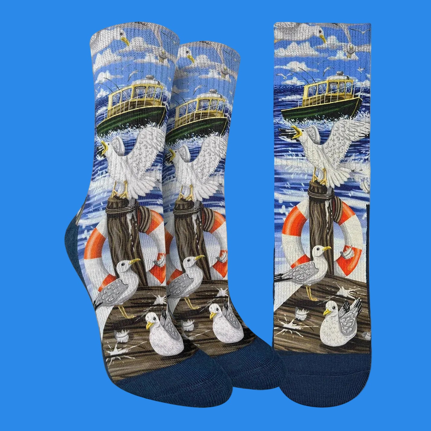 A pair of crew socks with a detailed nautical seagull and boat print, shown alongside a flat matching print panel on a white background.