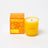 Vibrant yellow milkjar citrus scented essential oil candle in translucent glass jar made with coconut soy blend