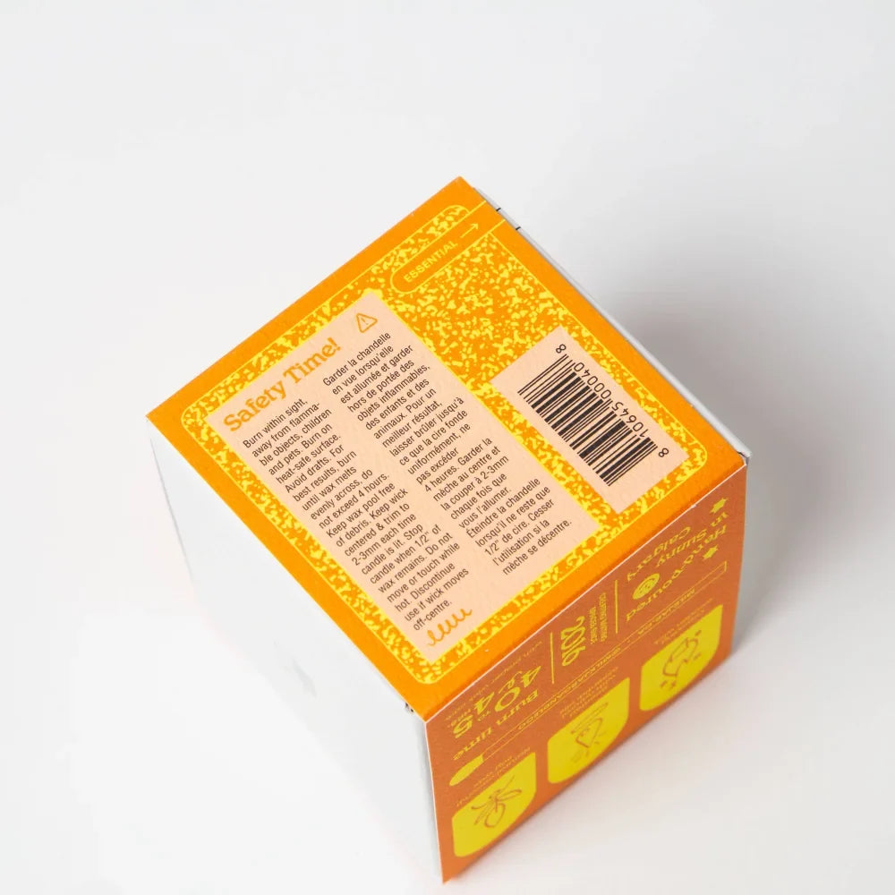 Orange cardboard box with yellow border showing safety instructions for citrus essential oil coconut soy candle 8oz back side
