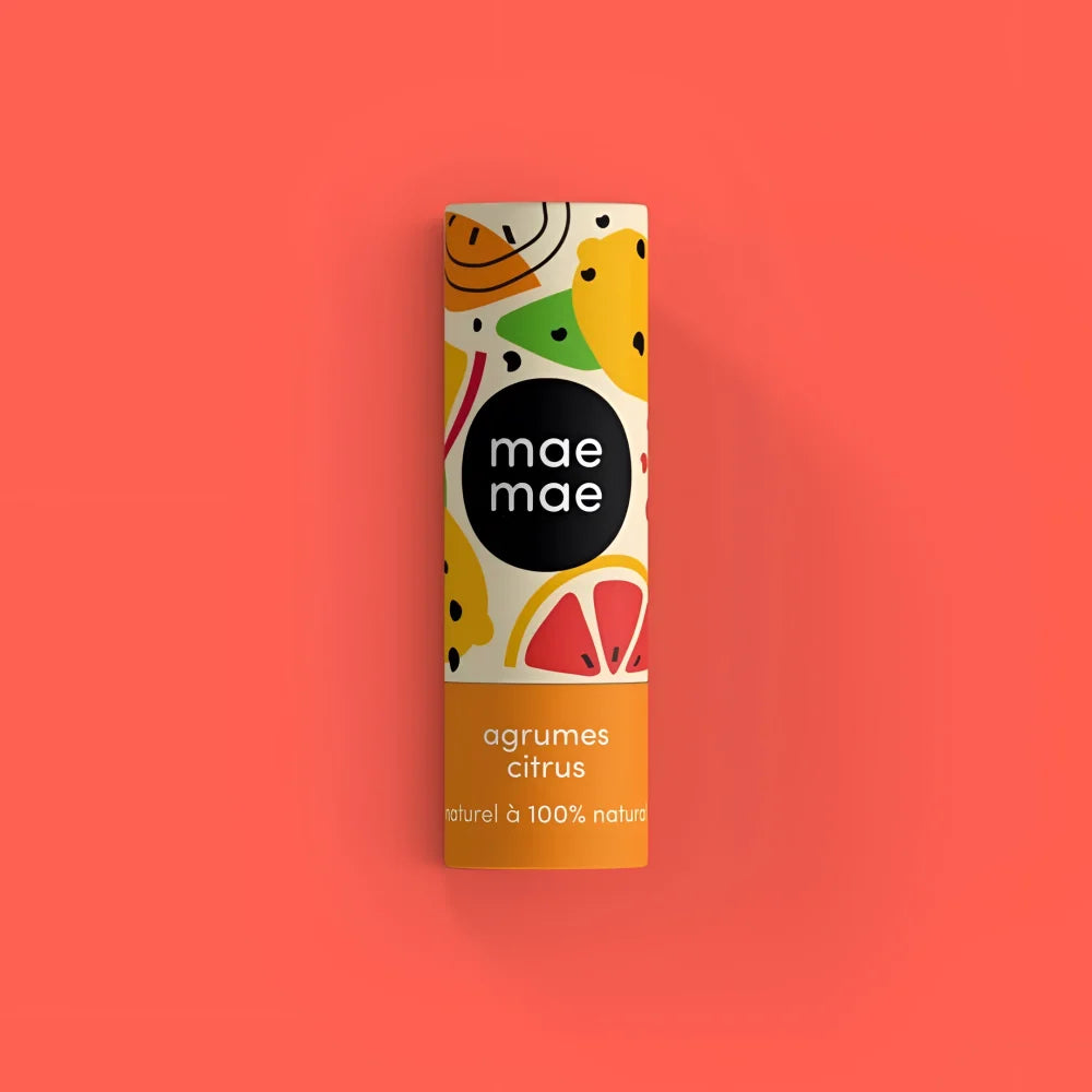 A cylindrical mae mae citrus natural lip balm tube with playful fruit design and orange band at the bottom