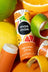 A colorful mae mae citrus natural lip balm tube with playful fruit design and orange and white packaging