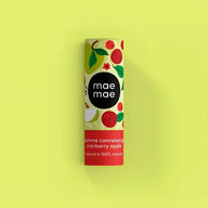 A cylindrical tube of mae mae cranberry apple natural lip balm with vibrant fruit design and bold red band for moisturizing lips