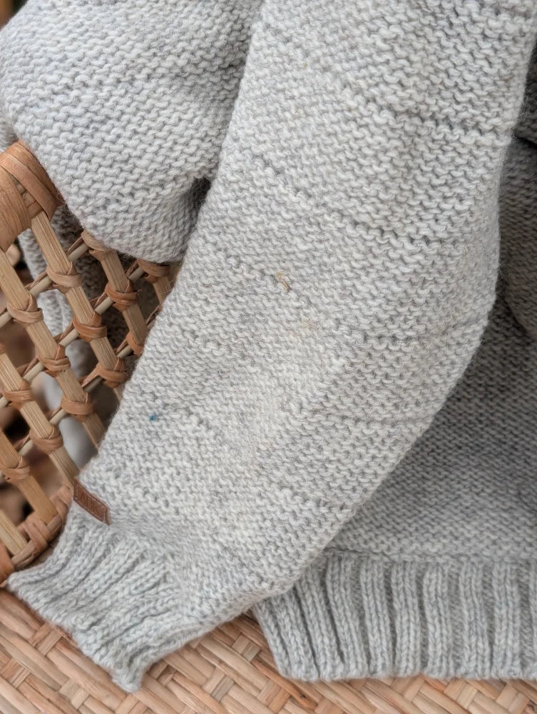 Light gray cream woolen calgary cardigan with soft fleece texture and ribbed cuffs made from zealand wool