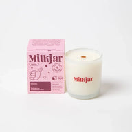 A creamy white dandy scent coconut soy candle in clear glass with wooden wick from angus oliver perfect with sheepskin rugs