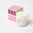 A creamy white coconut soy candle in a clear glass jar with red dandy logo perfect for angus oliver decor and sheepskin rugs