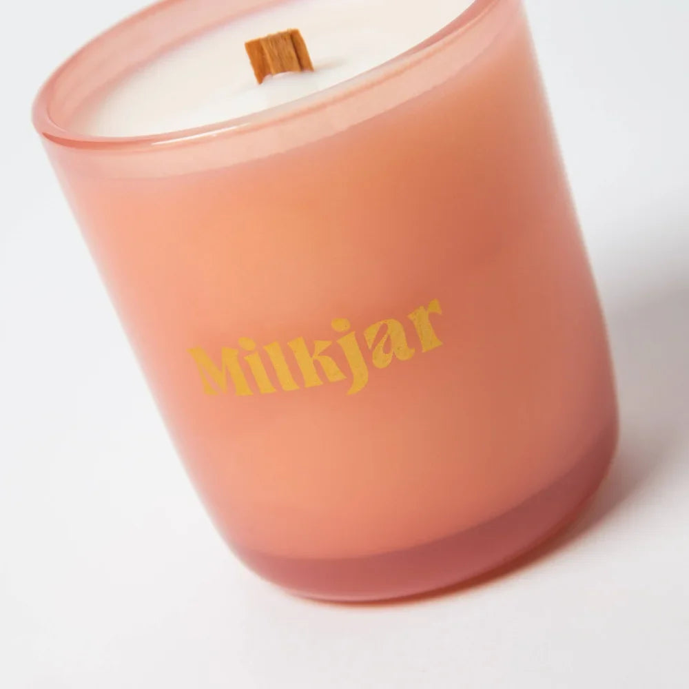 A peach frosted glass darjeeling patchouli and santal wooden wick candle jar by milkjar made with coconut soy wax