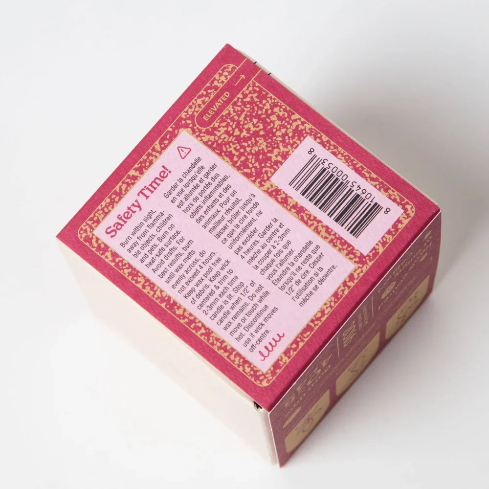 Back of darjeeling patchouli and santal coconut soy candle box with red and gold pattern and safety label