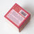 Back of darjeeling patchouli and santal coconut soy candle box with red and gold pattern and safety label