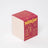 Darjeeling patchouli and santal coconut soy candle box in red and cream with gold lettering and suitcase graphic