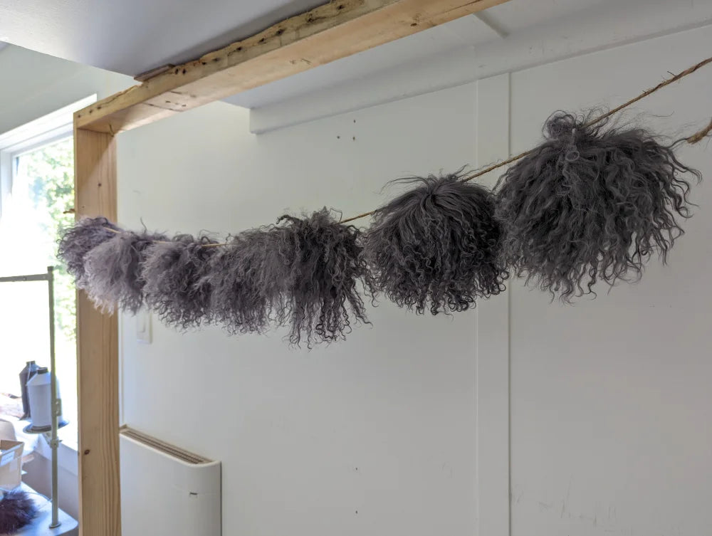 Dark grey sheepskin pom pom garland with fluffy gray accents