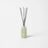 A sleek translucent green glass reed diffuser bottle with silver reeds for fresh laundry scent by angus oliver