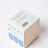 Beige cardboard box with blue floral border and safety instructions on the back for angus oliver french vanilla candle