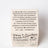 Cream-colored cardboard box for feel-gooder candle co fresh laundry rain cotton vanilla coco soy 8oz candle by angus oliver
