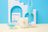 A creamy white cotton soy candle in a clear jar with a minimalist blue french vanilla angus oliver logo design