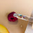 Clear glass dropper filled with glow & firm oil serum containing transparent seed oil and red flower petals