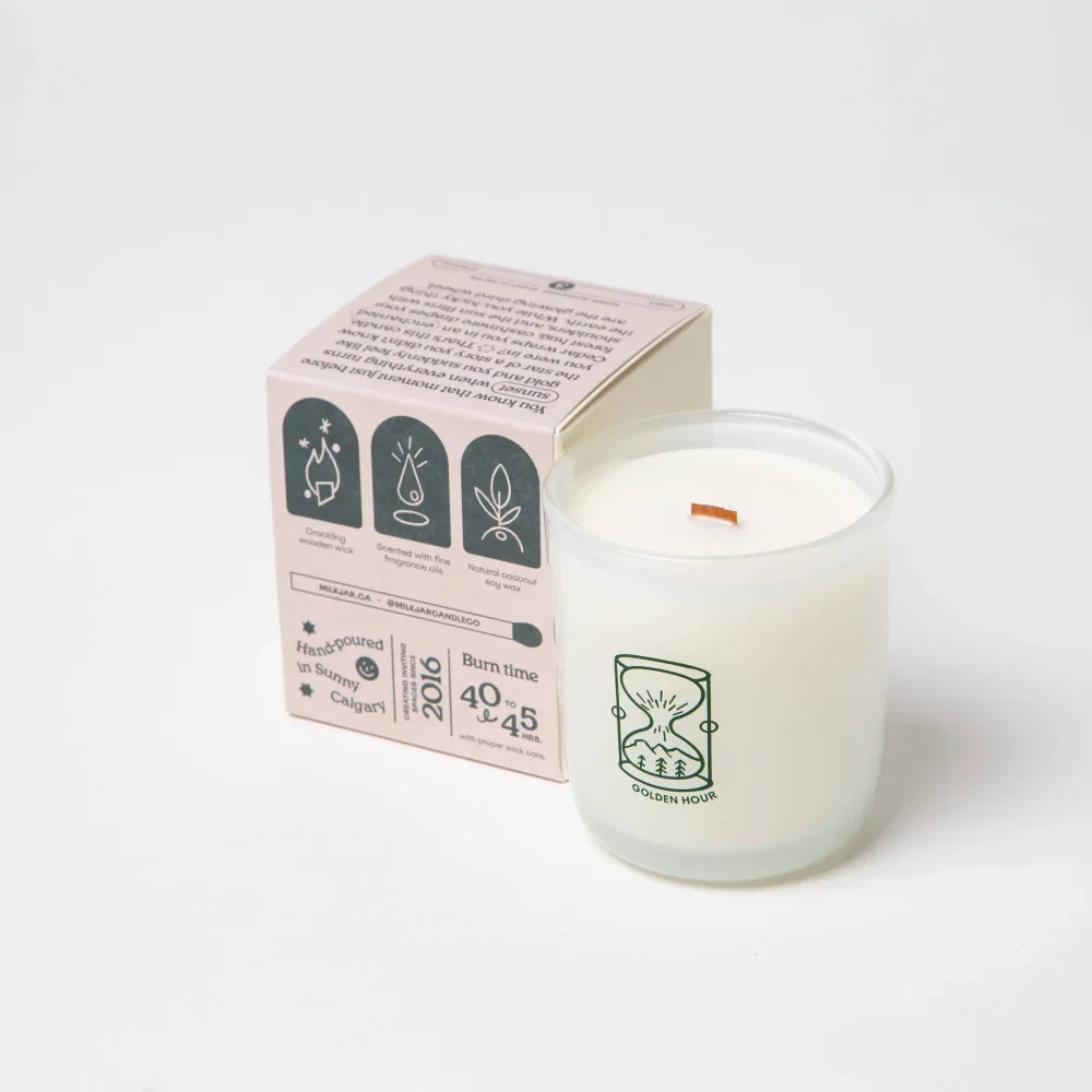 White glass candle with wooden wick and green hourglass logo made with coconut soy wax golden hour scent