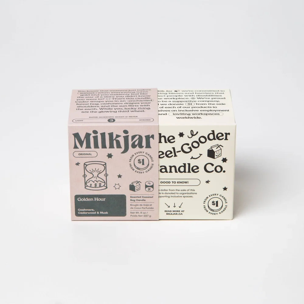 Pink and white cardboard box for golden hour milk jar candle with black text and star illustrations made of coconut soy wax