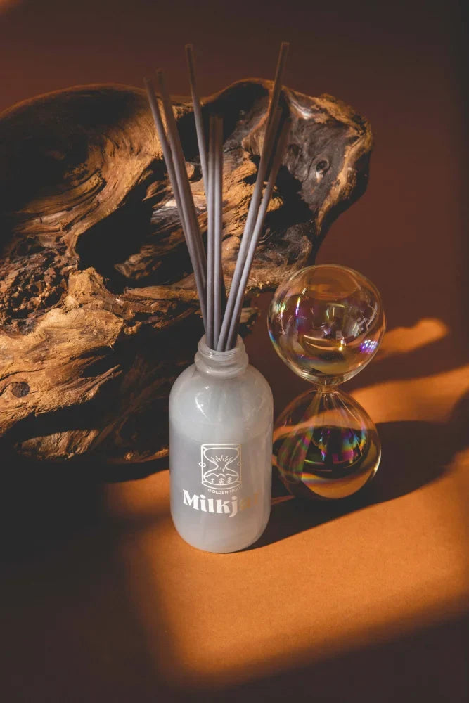 Milky brand white glass reed diffuser with gray sticks golden hour cashmere cedarwood and musk 4oz reed diffuser