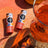 Two cylindrical hawaiian punch zinc lip balms with colorful tropical packaging featuring nano zinc oxide and fruit designs