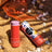 A vibrant red cylindrical lip balm with lavender cap featuring nano zinc oxide in colorful tropical mae mae packaging