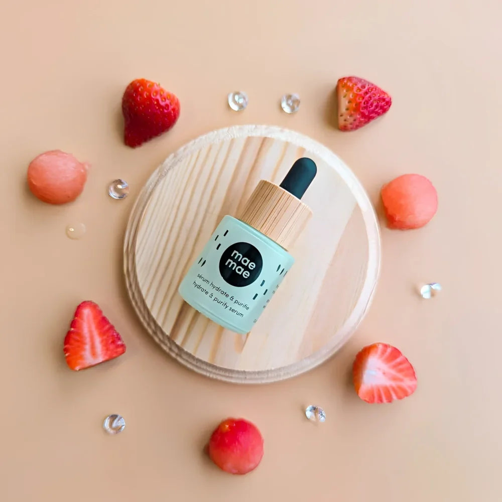 A mint green glass hydrating and purifying oil serum bottle with bamboo dropper by mae mae featuring strawberry seed oil