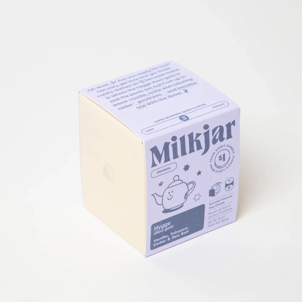 A lavender cardboard box for hygge vanilla tobacco cedar coconut soy 8oz milkjar candle with playful illustrations
