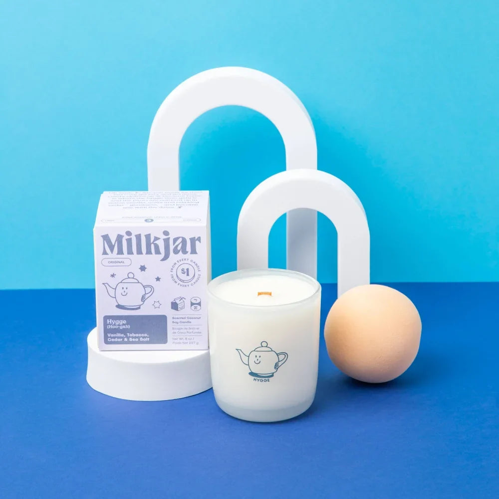 White frosted glass coconut soy candle with smiling teapot design orange wick by milkjar in vanilla tobacco cedar scent