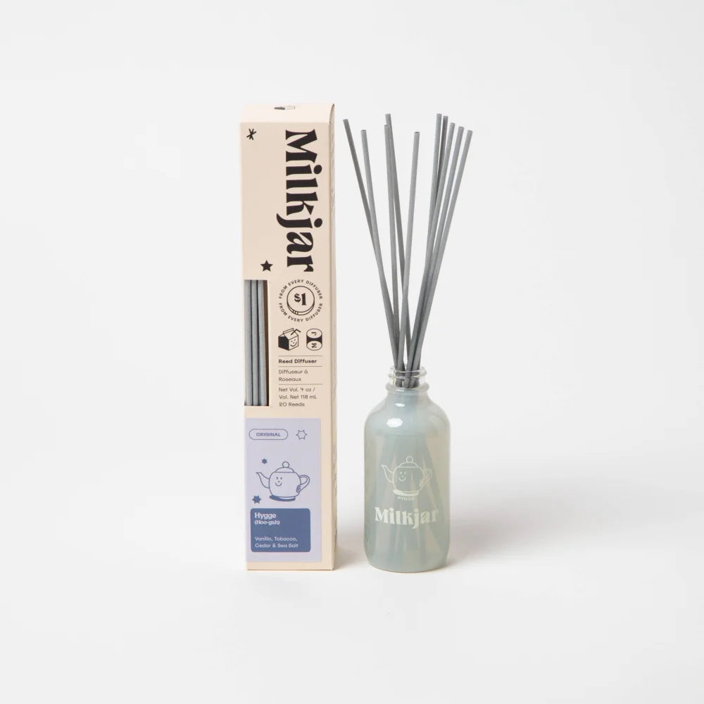 A translucent light blue frosted glass reed diffuser bottle with an etched teapot logo for sea salt scent