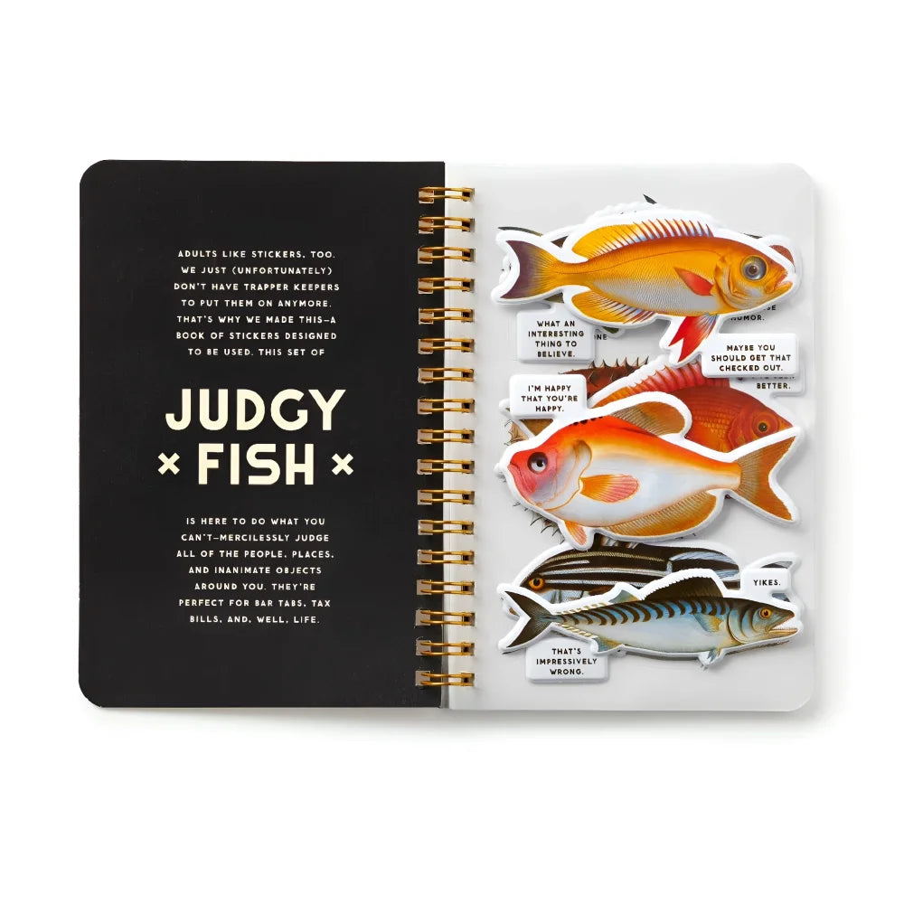 A judgy fish sticker book spiral notebook with colorful fish stickers on white pages and a black cover with gold foil text
