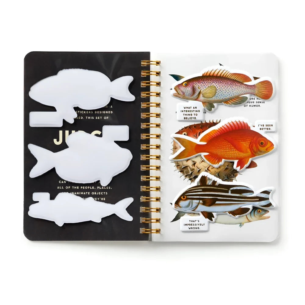 A spiral-bound judgy fish sticker book with colorful fish stickers on one page and white die-cut fish on black on the other