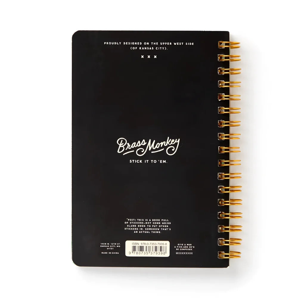 Black spiral-bound judging fish sticker book back cover with gold rings and white cursive brass monkey logo