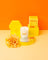 White milkjar candle in clear glass jar with orange branding lemonades coconut soy 8 oz candle