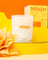White milkjar coconut soy candle in frosted glass jar with orange lettering lemonade coconut lime pine scent