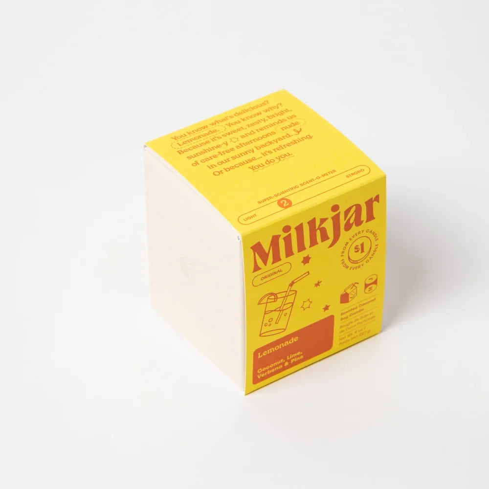 Bright yellow cardboard box for coconut soy lemonade candle with orange text and drink illustration on front