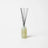A sleek pale green glass reed diffuser with gray reeds for lemonade coconut lime verbena and pine scent