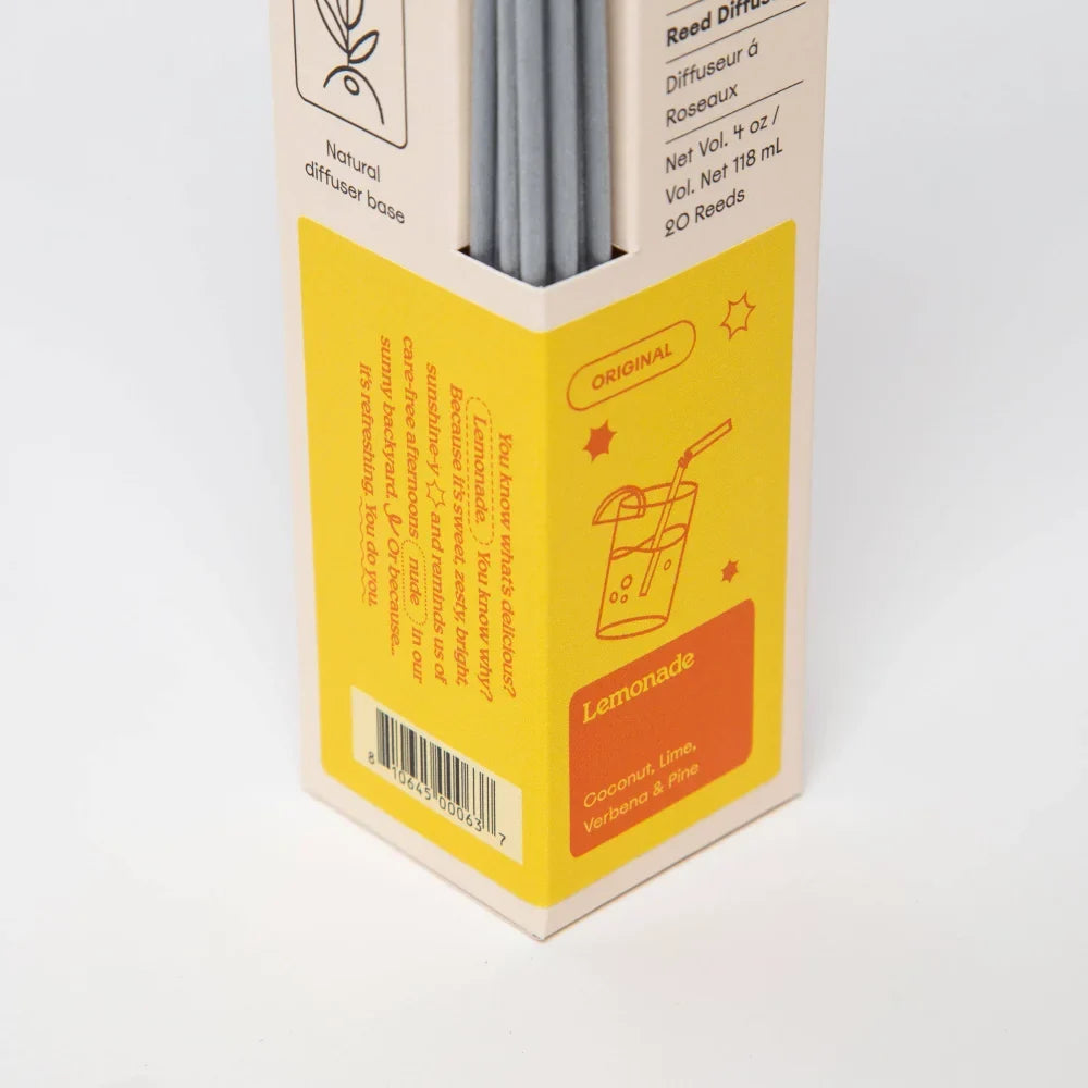 Yellow and orange labeled box with silver reed diffuser sticks for lemonade coconut lime verbena and pine 4oz reed diffuser