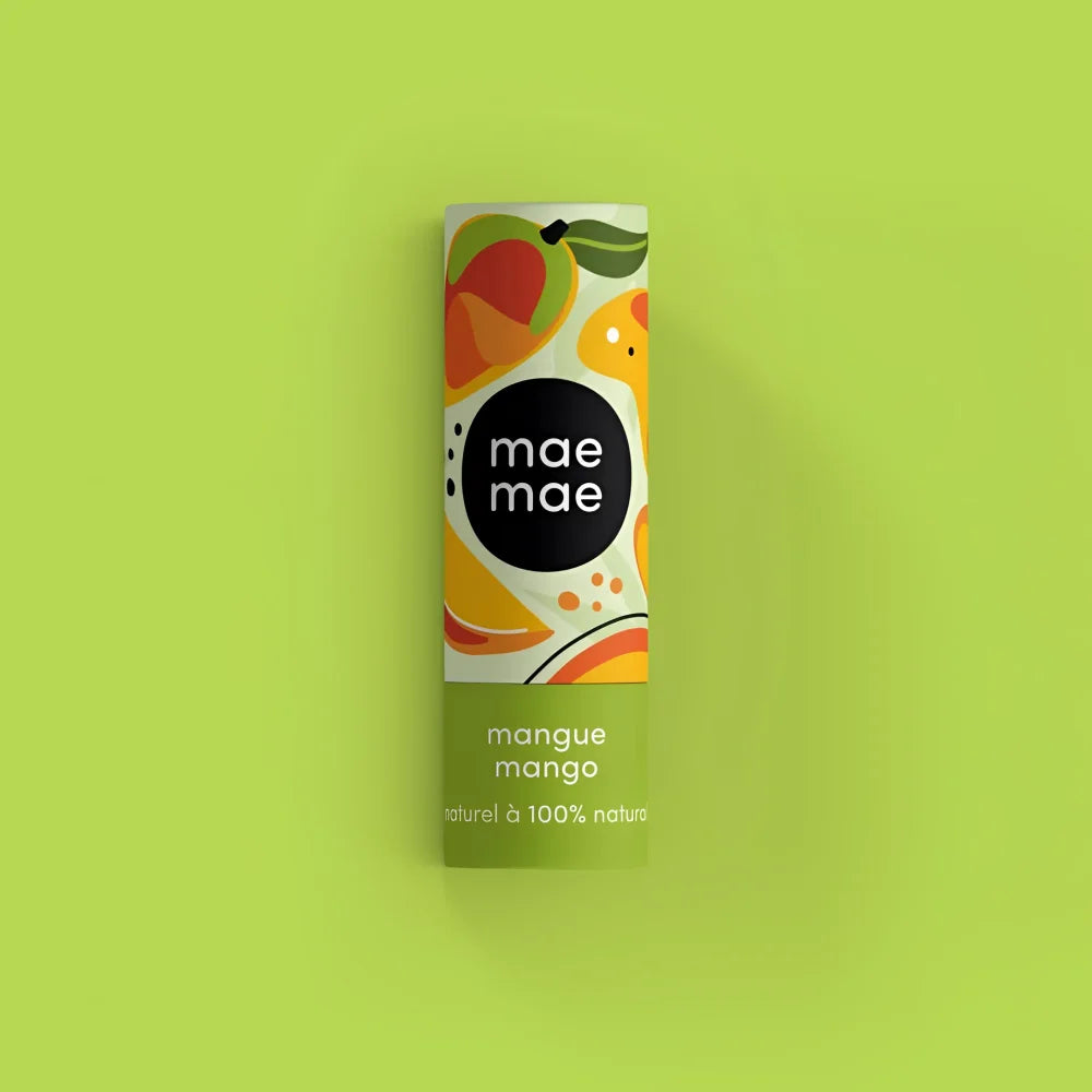 A cylindrical tube of mae mae mango natural lip balm with a bright green tropical fruit label and bold black text