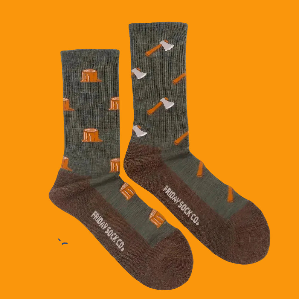 A pair of olive green and brown merino wool socks with orange tree stumps and axes perfect for hiking and trails