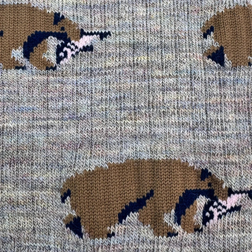 Gray knit merino wool socks with brown and navy badger pattern and pink accents for warm breathable wear